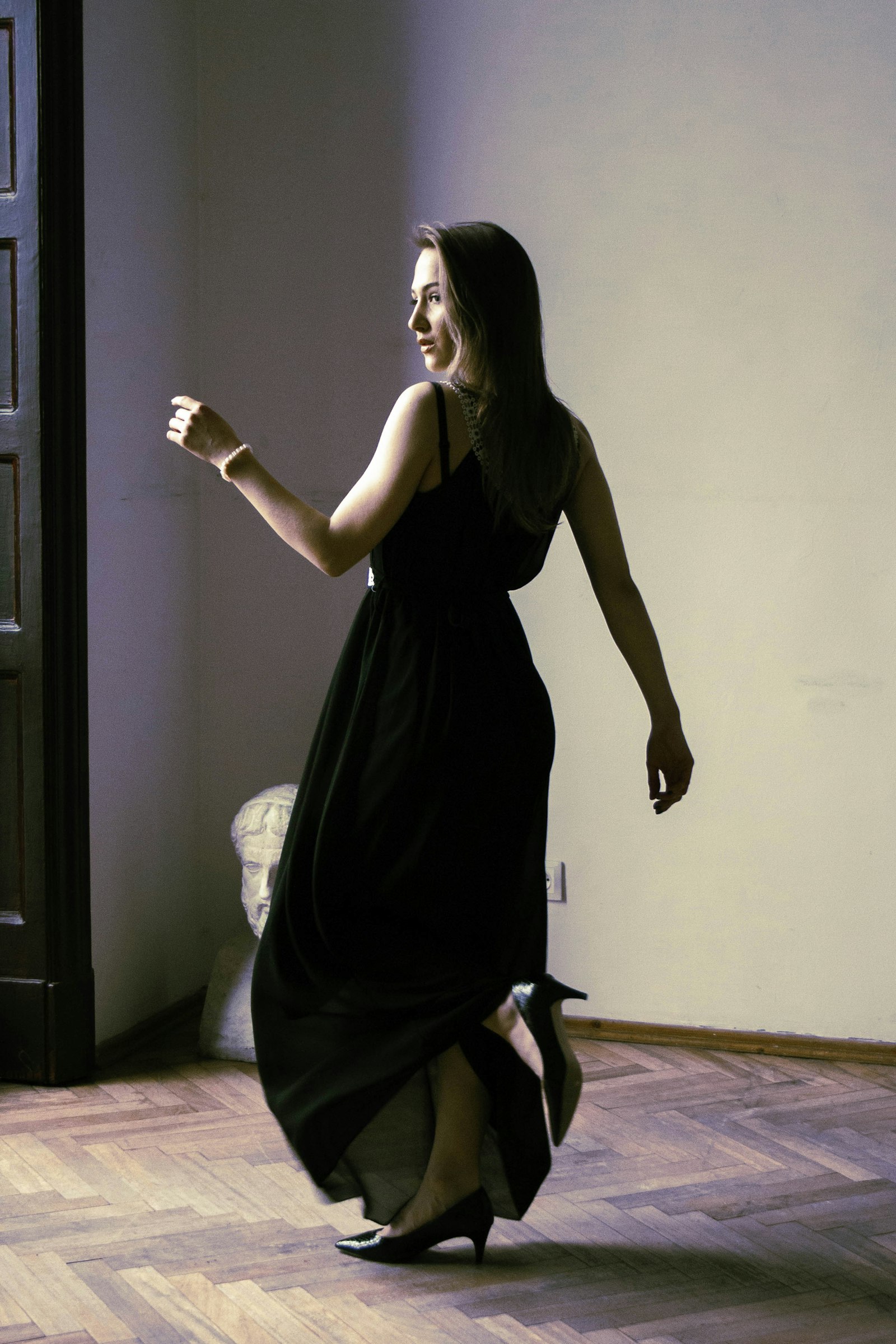 Model in a black evening gown mid-movement, from the Elegance template demo