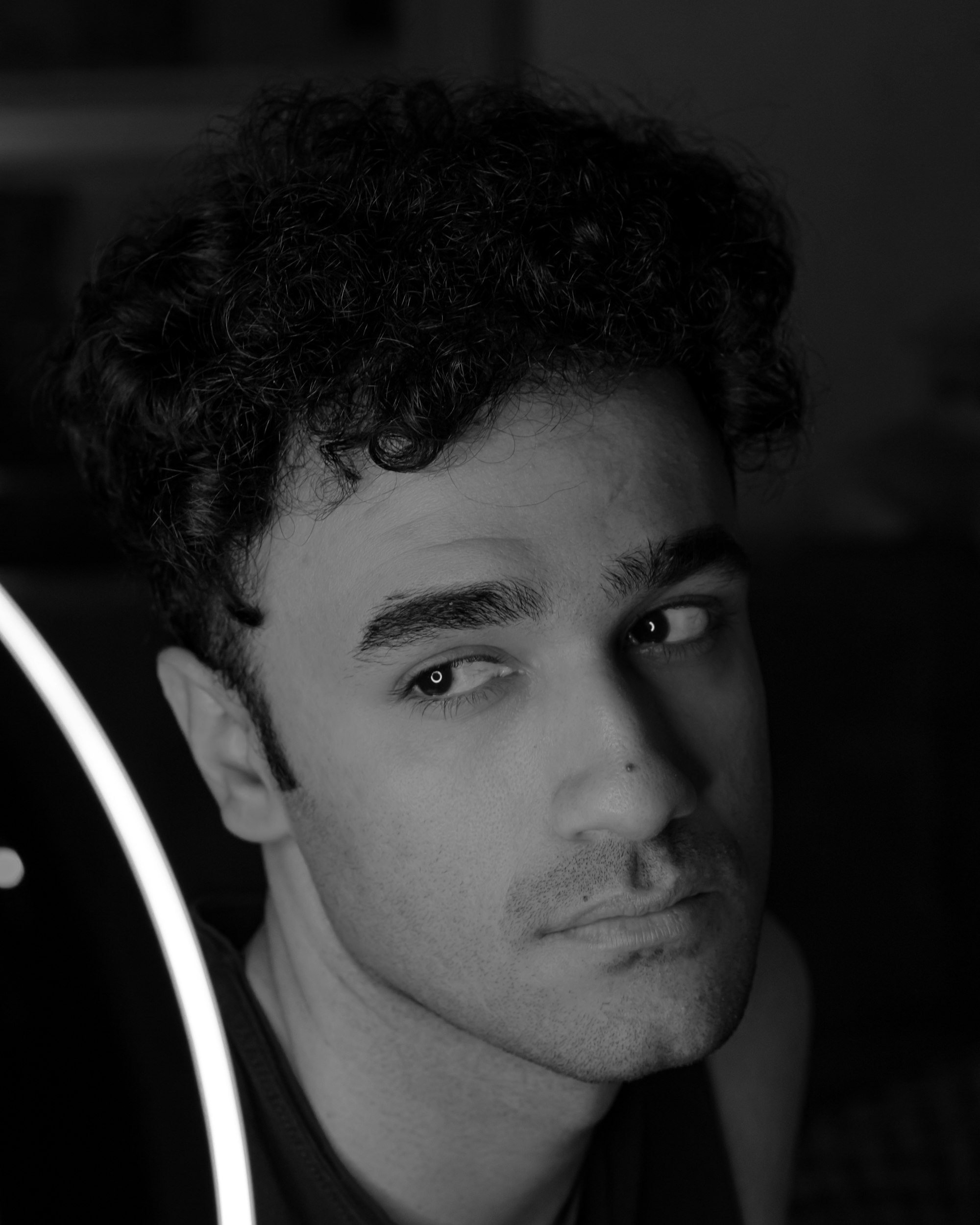Black and white studio portrait of a male model, from the Atelier template demo
